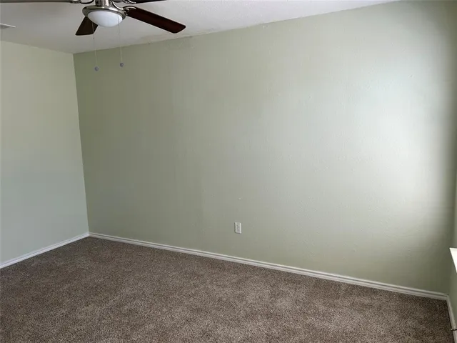 an empty room with a fan