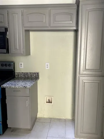 a kitchen with a cabinets and a stove top oven