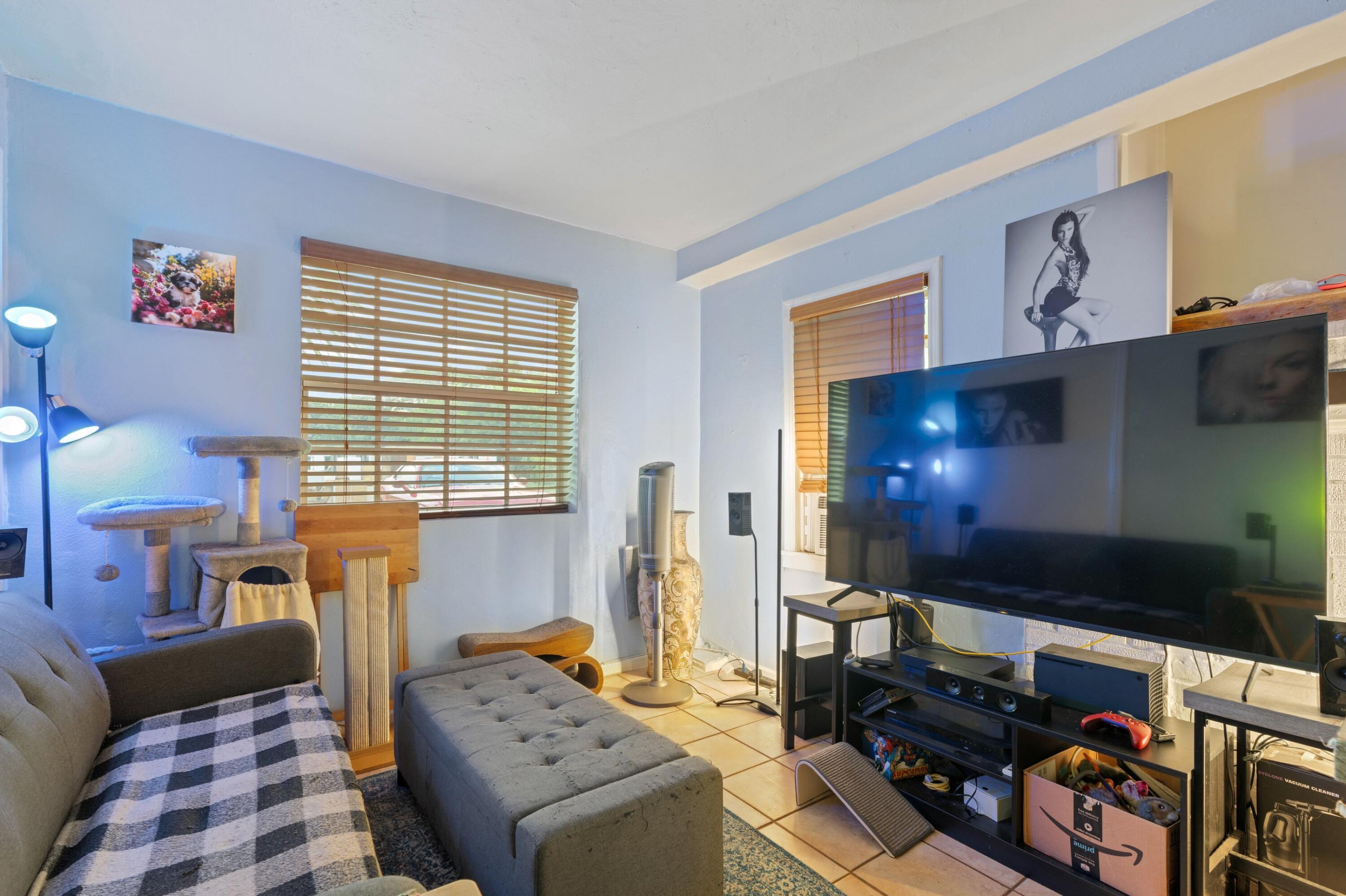 1831 Juno Road North Palm Beach, FL 33408 - Photo 21 of 37 a bedroom with furniture and a flat screen tv