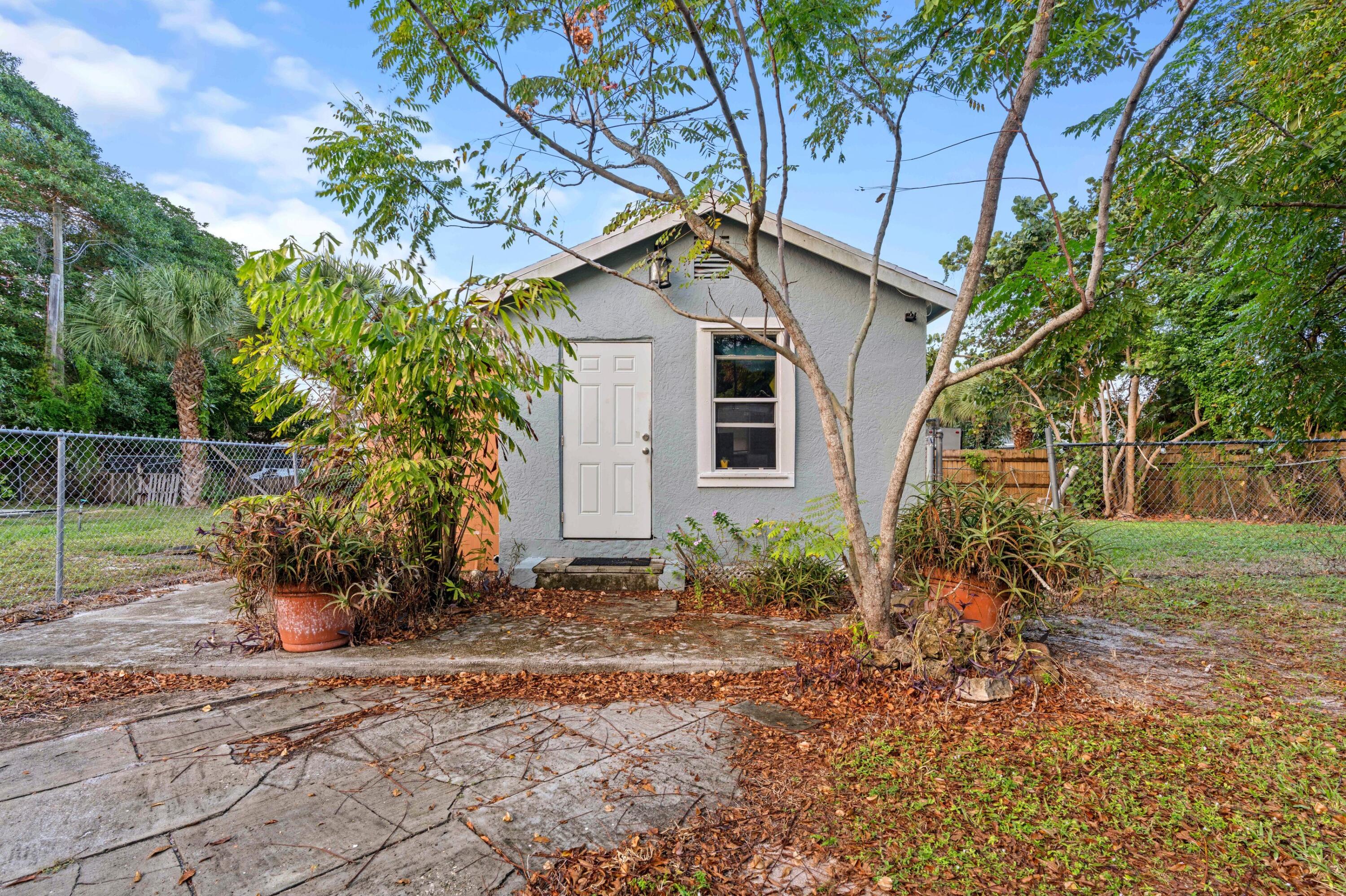 1831 Juno Road North Palm Beach, FL 33408 - Photo 24 of 37 a house that has a tree in front of the house