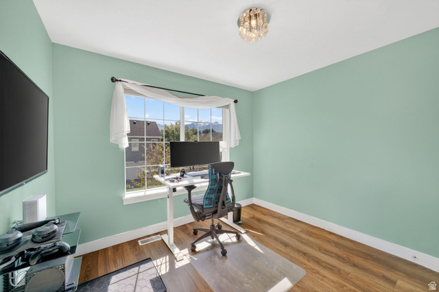 7872 Farm House Lane Midvale, UT 84047 - Photo 24 of 39 Room featuring wood-finish flooring and light green walls