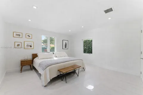 a bedroom with a bed and a night stand