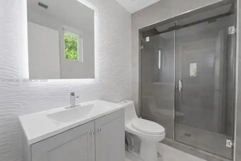 a bathroom with a sink toilet and shower