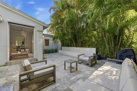 a view of backyard with seating area and green space