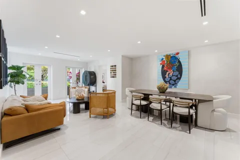 a living room with furniture a table and a flat screen tv
