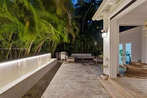 a view of house with backyard and sitting area