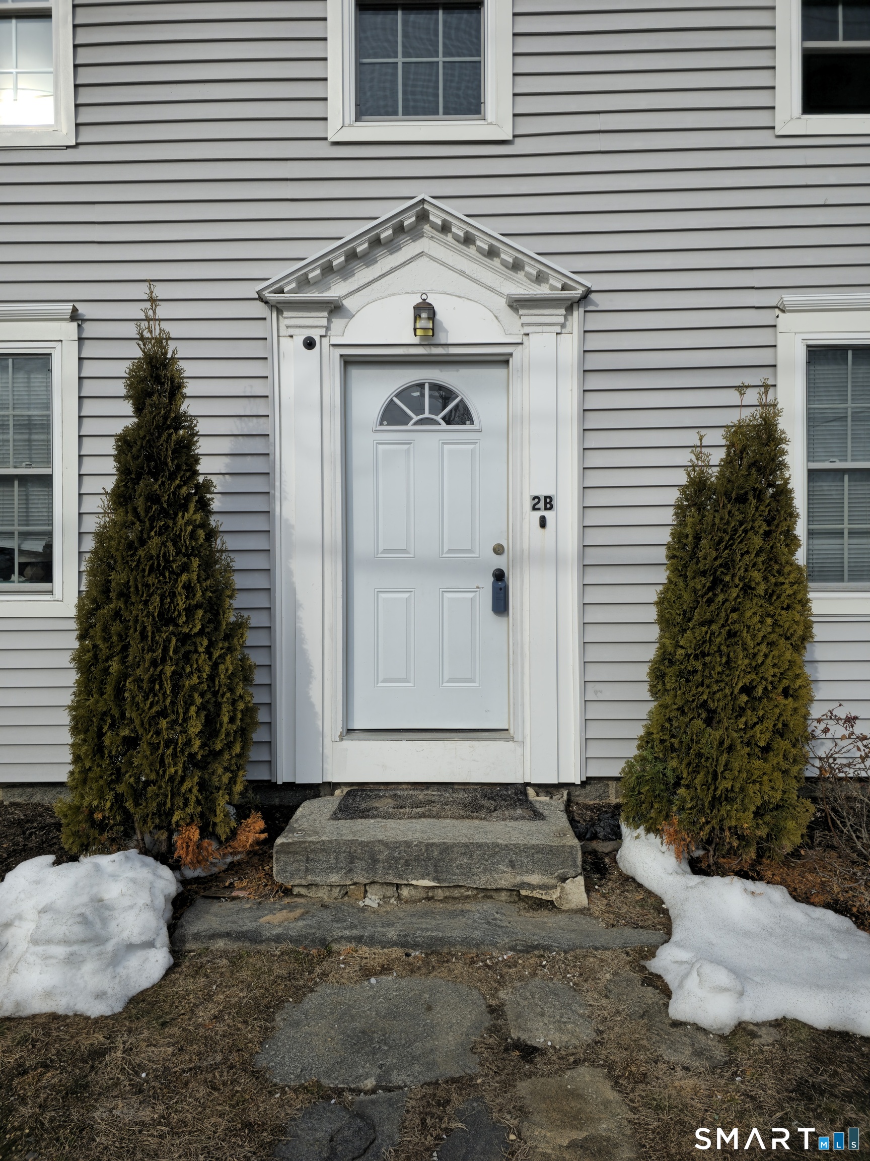 151 East Main Street, Unit 2B Clinton, CT 06413 - Photo 1 of 10 a front view of a house with garden
