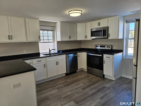 a kitchen with a sink stove and cabinets