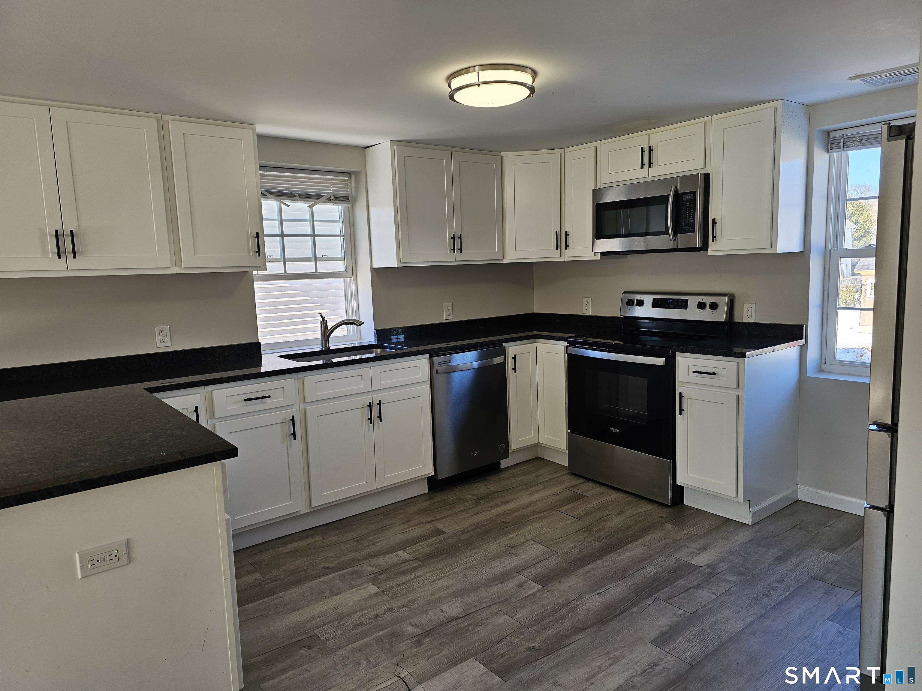 151 East Main Street, Unit 2B Clinton, CT 06413 - Photo 3 of 10 a kitchen with a sink stove and cabinets