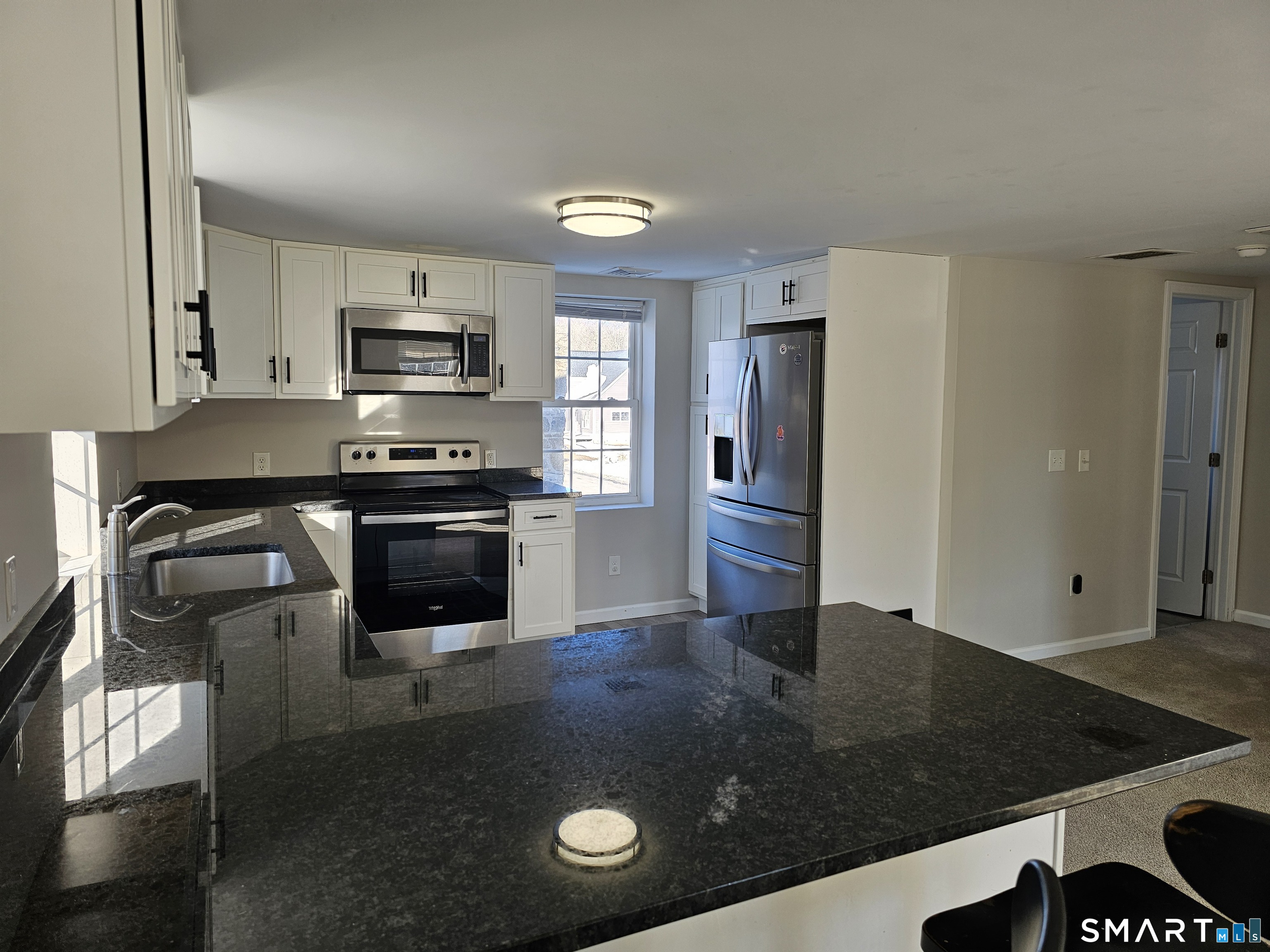 151 East Main Street, Unit 2B Clinton, CT 06413 - Photo 4 of 10 a kitchen with stainless steel appliances granite countertop a stove a sink and a refrigerator