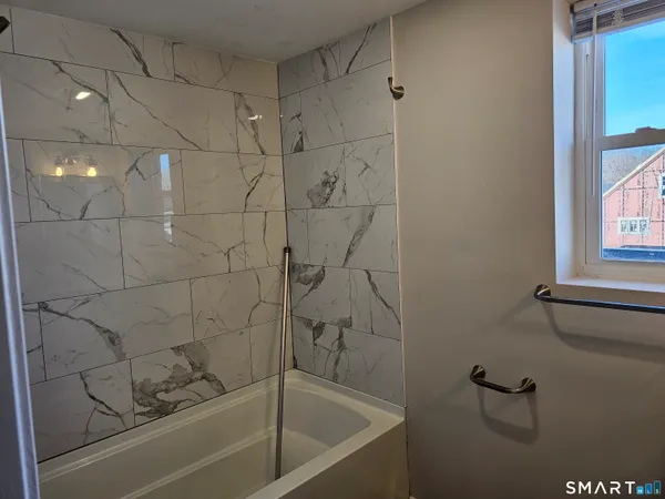 a bathroom with a bathtub and shower