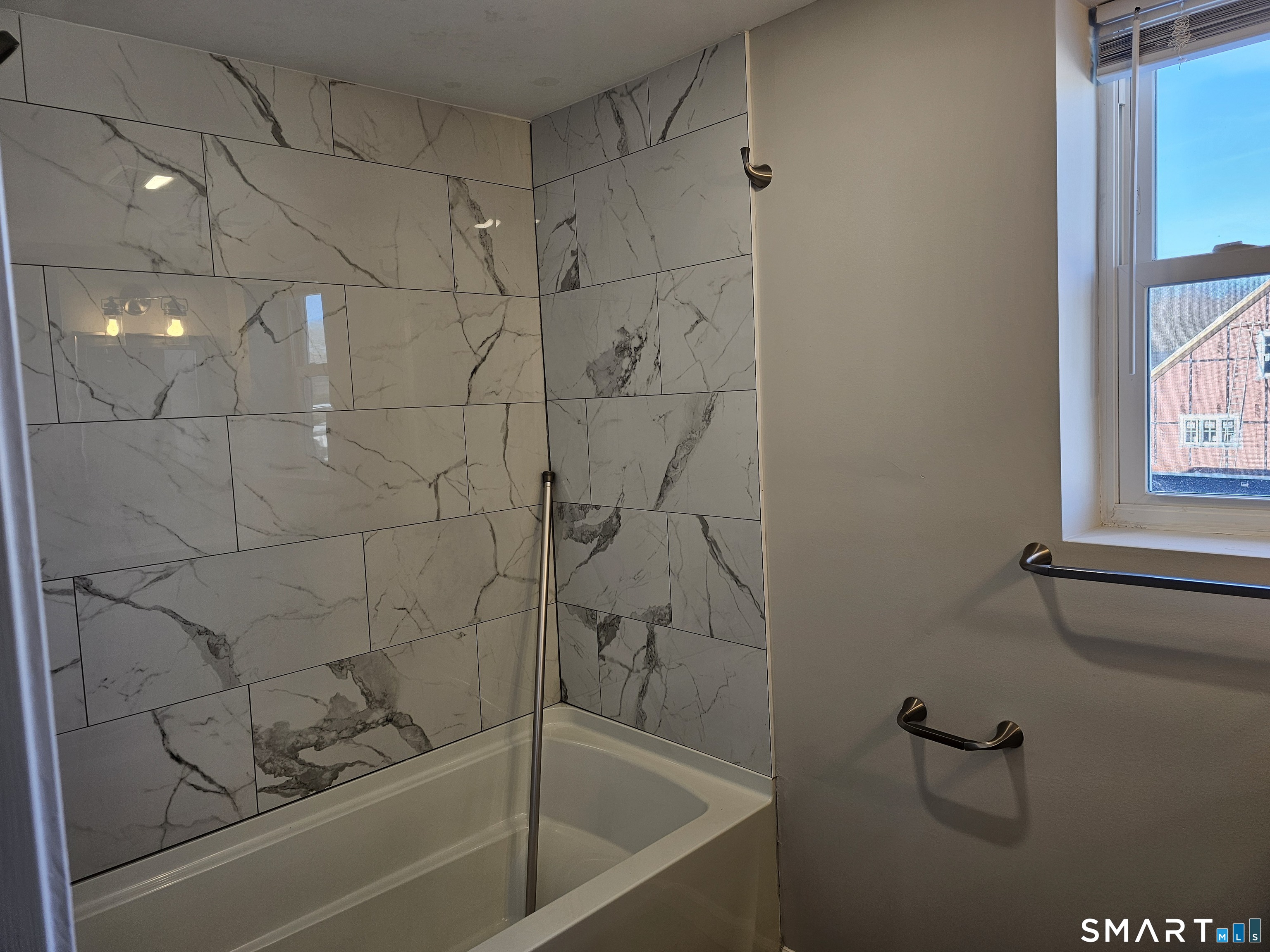 151 East Main Street, Unit 2B Clinton, CT 06413 - Photo 5 of 10 a bathroom with a bathtub and shower