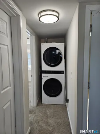 a view of a hallway with washer and dryer