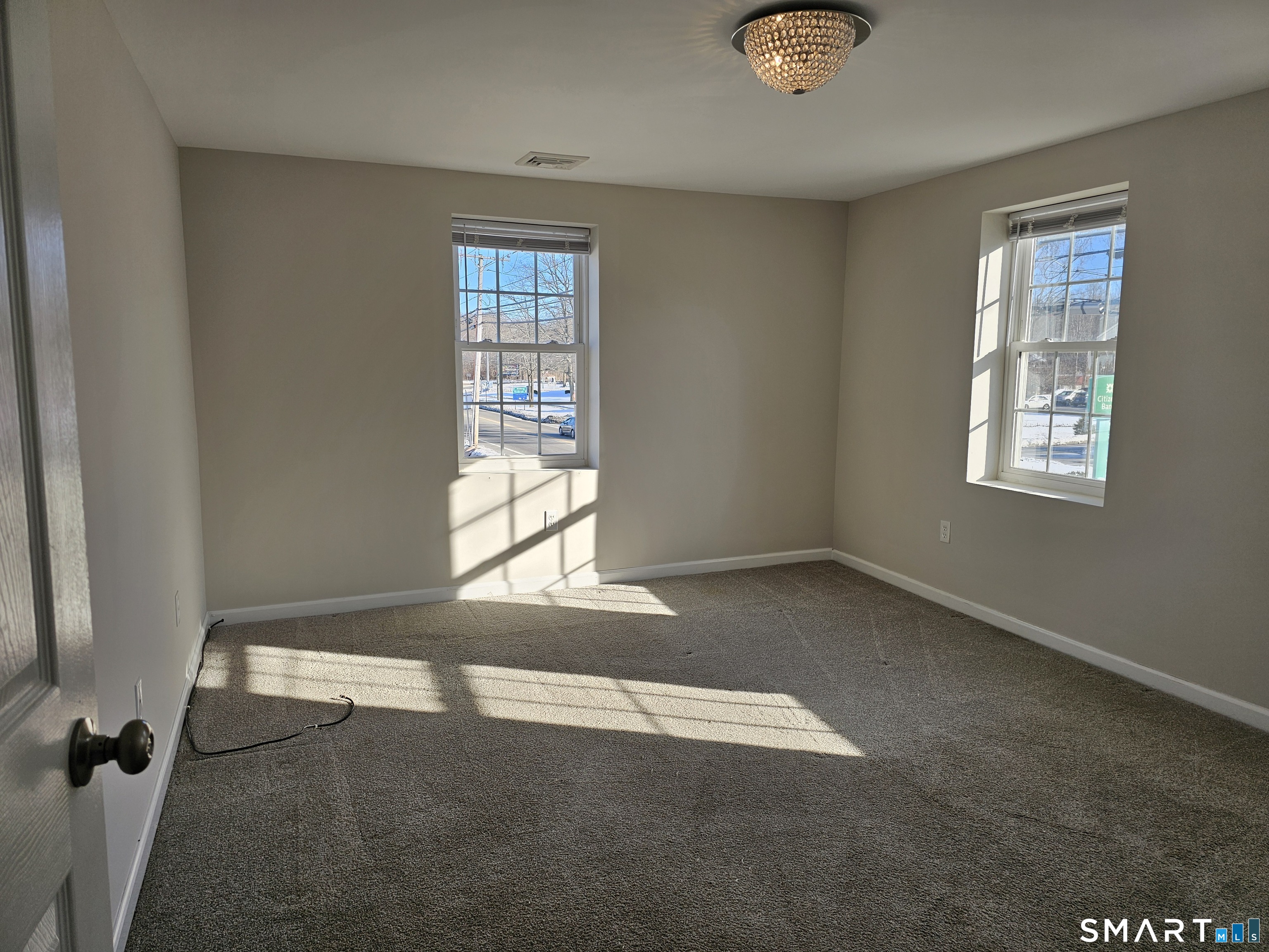 151 East Main Street, Unit 2B Clinton, CT 06413 - Photo 8 of 10 an empty room with windows