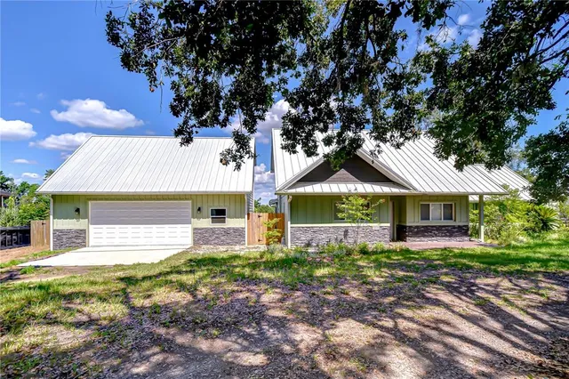 a front view of house with yard and green space