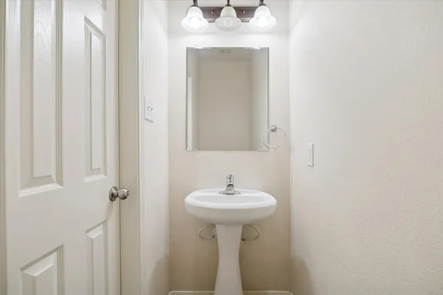 a bathroom with a sink a mirror and a window