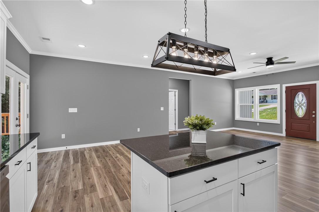223 Maple Drive Anderson, SC 29621 - Photo 11 of 45 A contemporary open-concept space features warm wood flooring and sleek granite counters, perfect for modern living.
