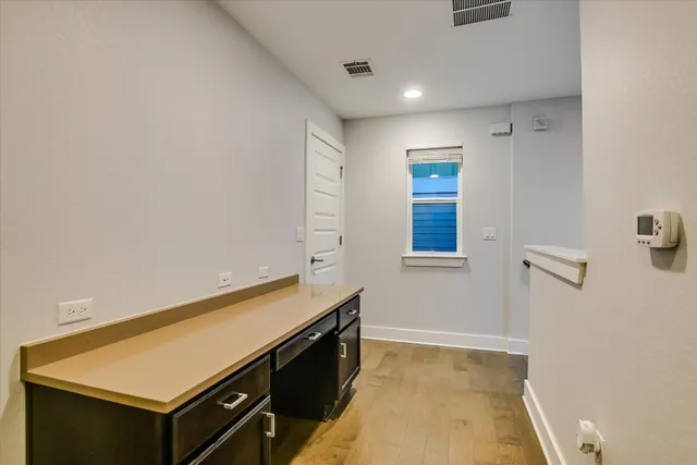 a view of kitchen with stainless steel appliances cabinets and a counter top