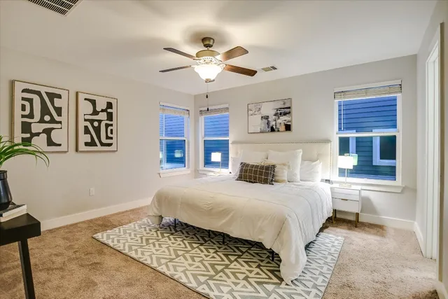 a bedroom with a large bed and a window