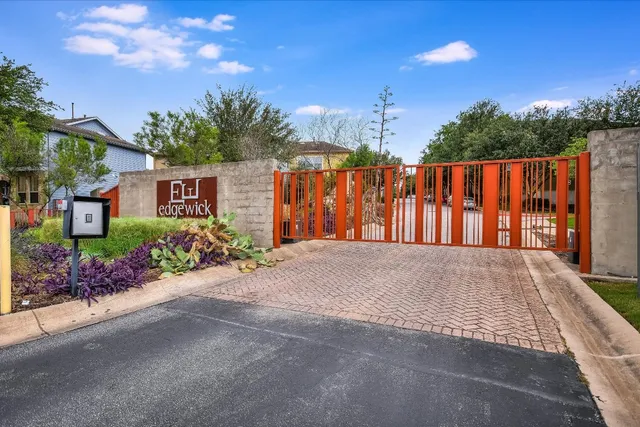 a view of a house with a yard and potted plants