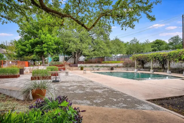 a view of a swimming pool with an outdoor seating