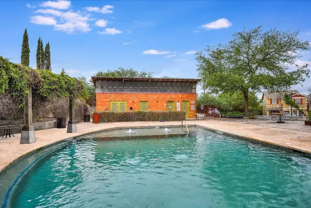 a swimming pool with outdoor seating and yard