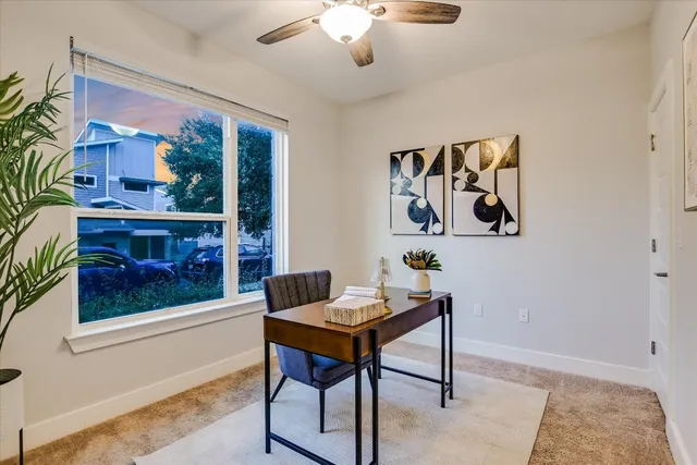 a living room with furniture and a painting on the wall