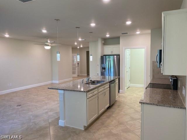 5701 Mayflower Way, Unit 1307 Immokalee, FL 34142 - Photo 3 of 8 a kitchen with stainless steel appliances granite countertop a sink and a refrigerator