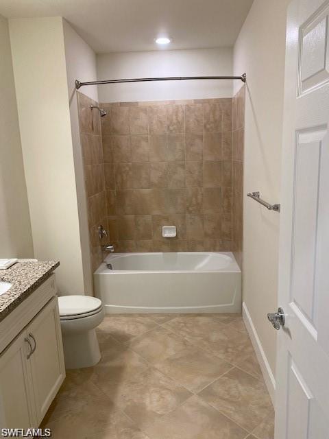 5701 Mayflower Way, Unit 1307 Immokalee, FL 34142 - Photo 7 of 8 a bathroom with a granite countertop bathtub shower and toilet