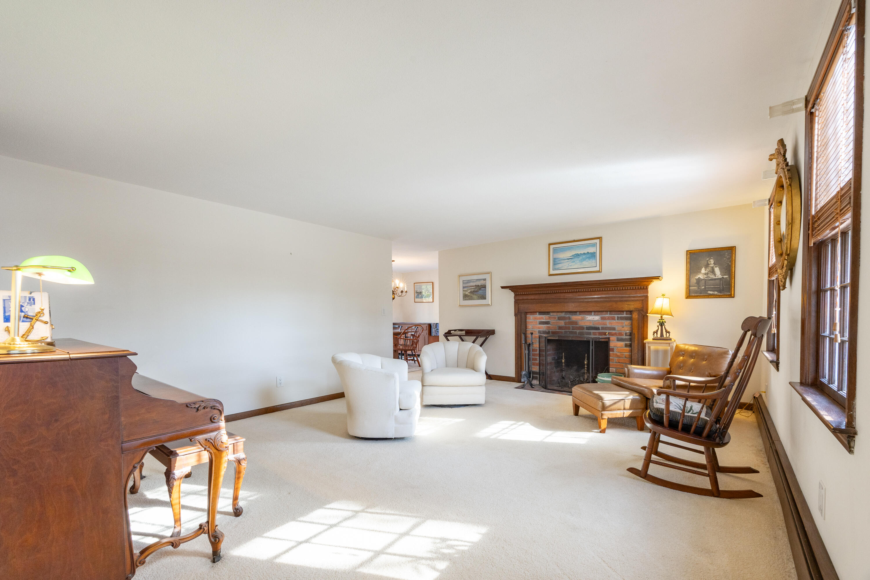 12 Canapitsit Drive East Falmouth, MA 02536 - Photo 12 of 34 a living room with furniture a fireplace and a flat screen tv