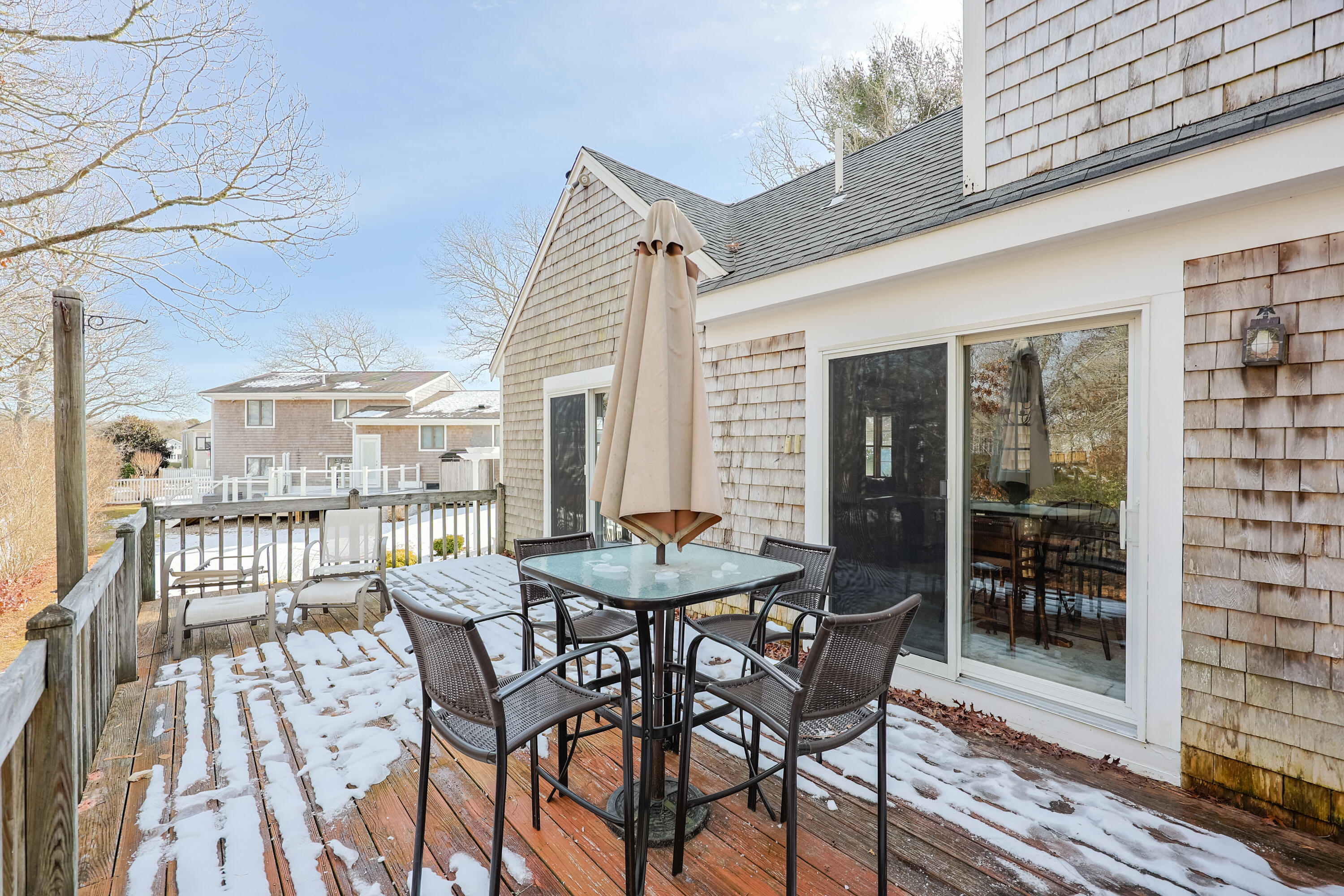 12 Canapitsit Drive East Falmouth, MA 02536 - Photo 34 of 34 a view of a patio with a table and chairs and potted plants