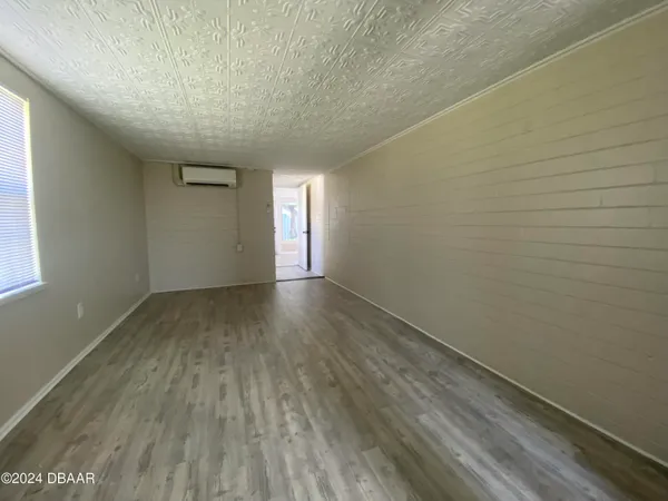 a view of room with window and hardwood floor