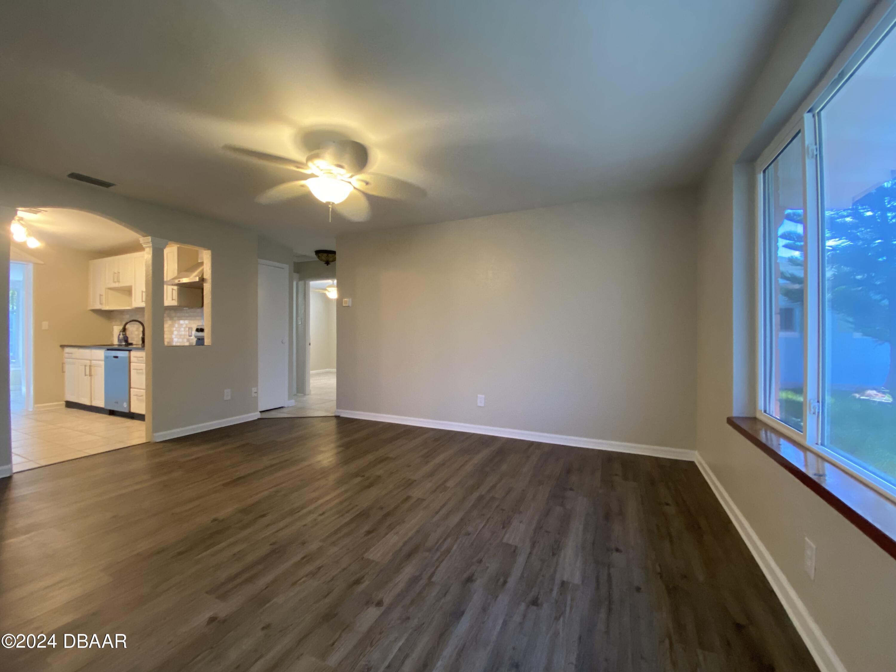 28 Rivershore Drive Ormond Beach, FL 32176 - Photo 4 of 16 a view of an empty room with window and wooden floor