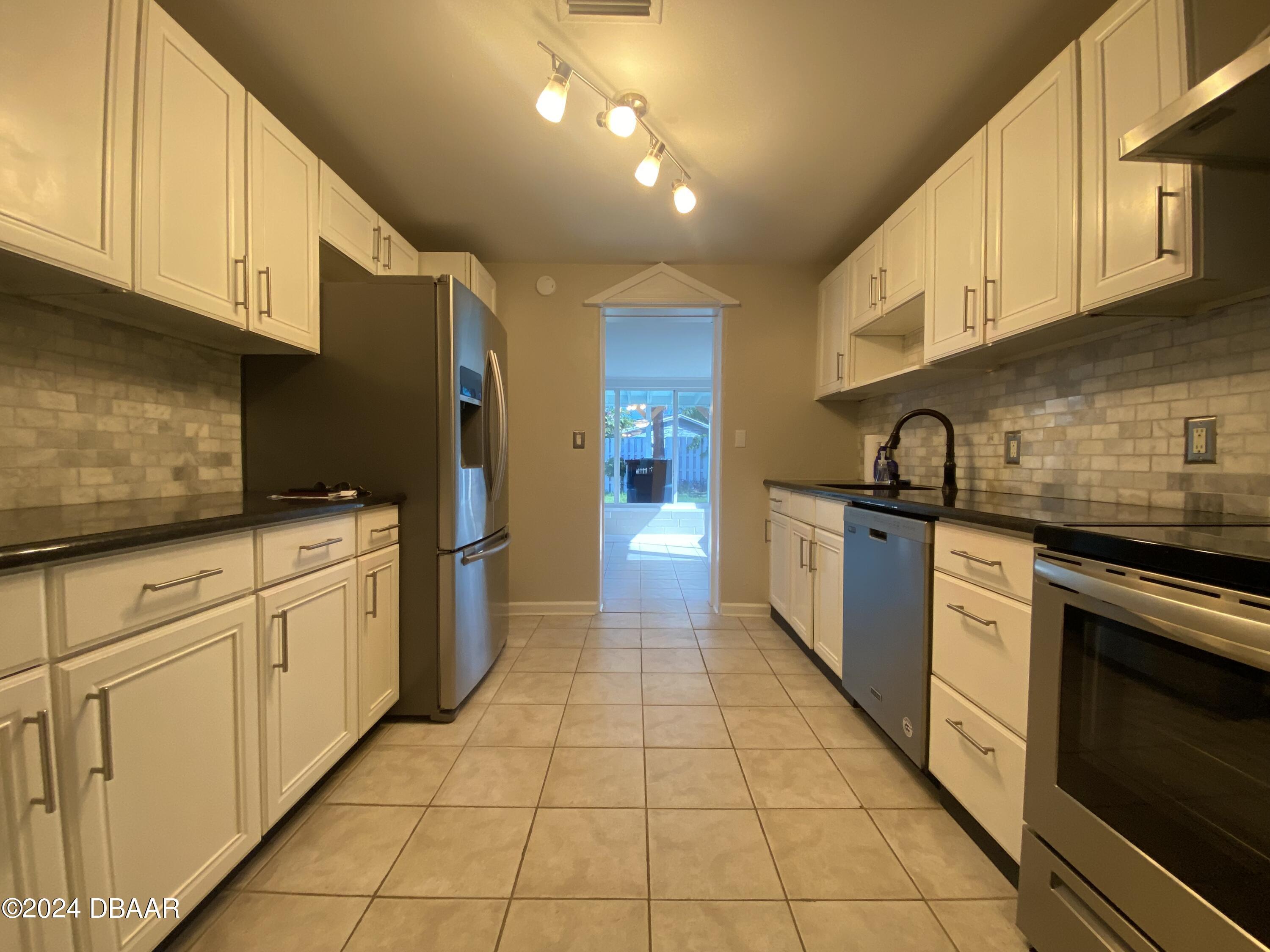 28 Rivershore Drive Ormond Beach, FL 32176 - Photo 6 of 16 a kitchen with a sink cabinets and appliances