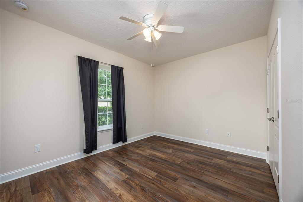 8216 Northwest 54th Street Gainesville, FL 32653 - Photo 14 of 58 wooden floor in an empty room with a window