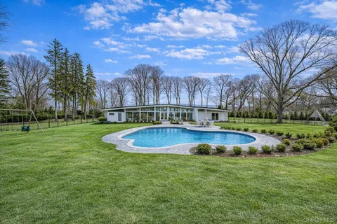a view of a swimming pool with a yard