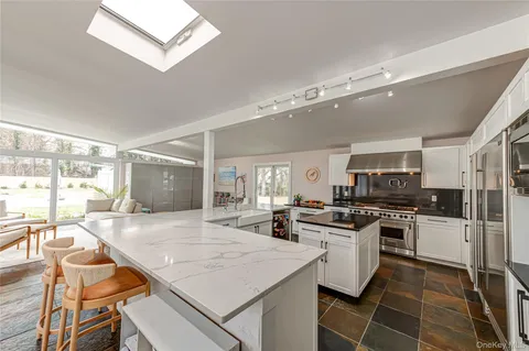 a kitchen with granite countertop a stove oven and sink