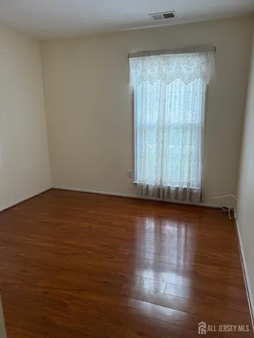 a view of wooden floor and windows in a room