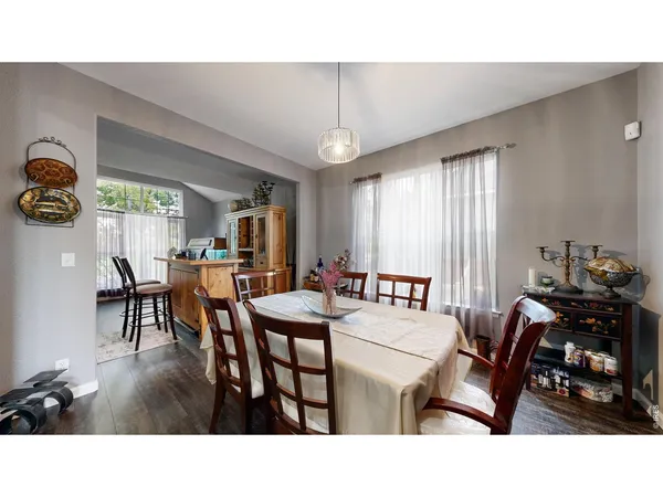 a living room with dining room and window