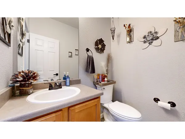 a bathroom with a sink mirror and toilet