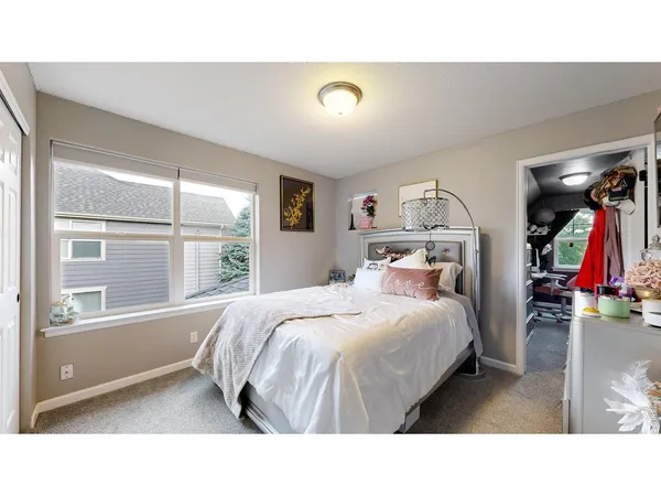 a bedroom with a bed and a window