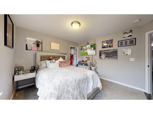 a bedroom with a bed and a desk