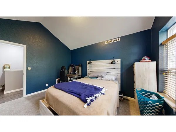 a living room with a bed and a flat screen tv
