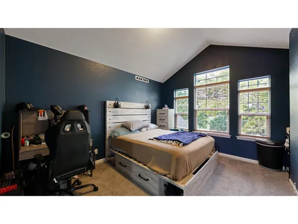 a living room with a bed furniture and a window