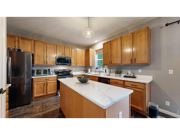 a kitchen with a refrigerator a sink dishwasher with a stove and refrigerator