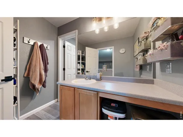 a kitchen with a sink a refrigerator and a view of living room