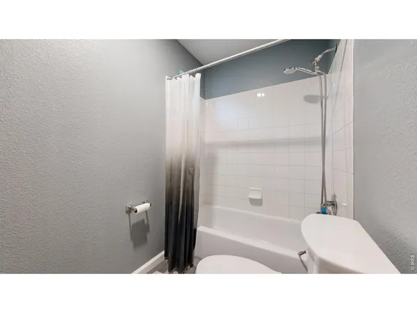 a bathroom with a tub shower and a sink