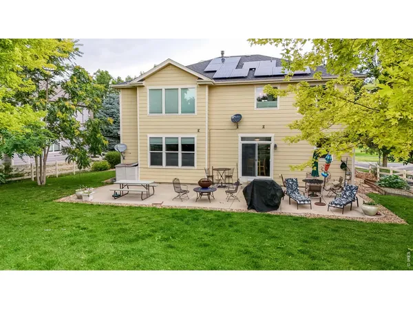 a house view with a sitting space garden and patio