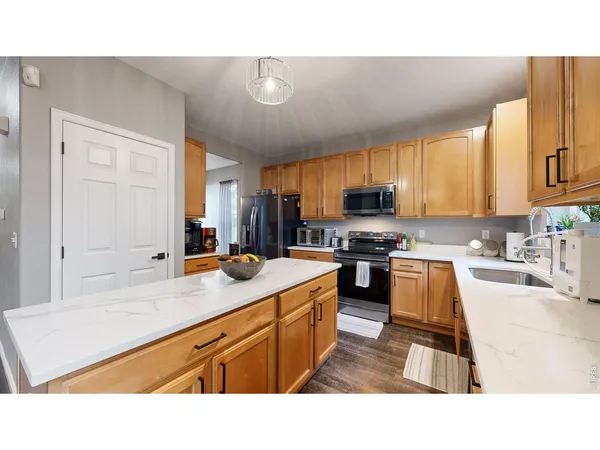 a kitchen with sink a stove and cabinets