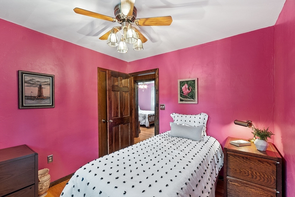6 Ingalls Road Tyngsborough, MA 01879 - Photo 18 of 38 a bedroom with a bed dresser and a chandelier